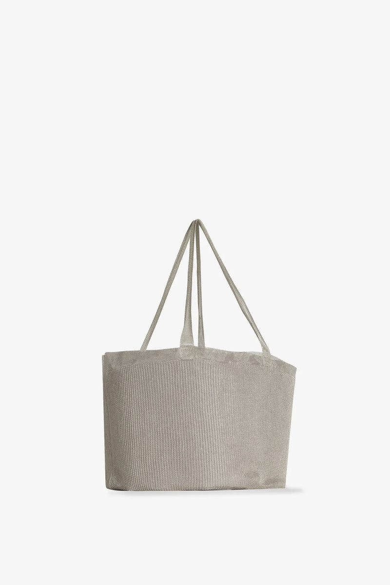 Side slanted view of steel mesh bag on white background, with no model shown.