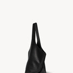 Side view of black small bindle stitch bag on white background, with no model shown.