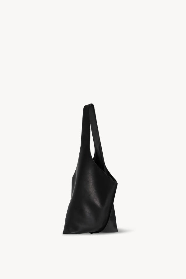 Side view of black small bindle stitch bag on white background, with no model shown.