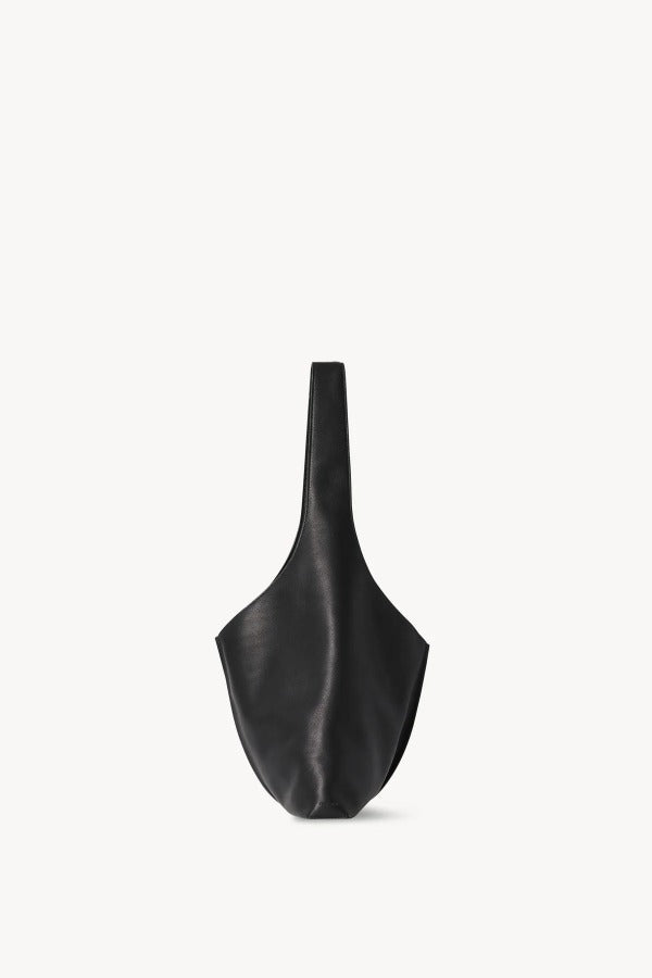 Alternate side view of black small bindle stitch bag on white background, with no model shown.