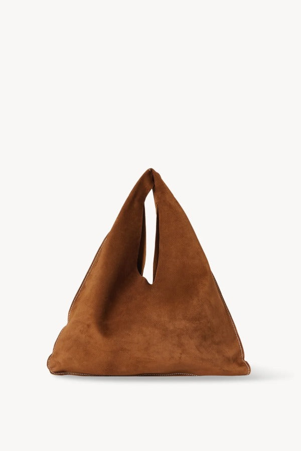 Front view of bistre/ecru small suede bindle bag on white background, with no model shown.