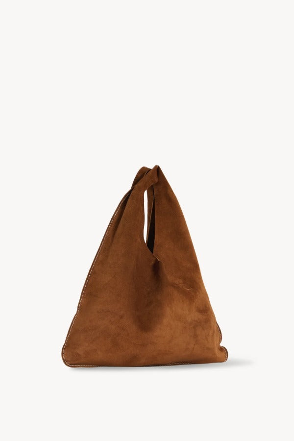 Front slanted view of bistre/ecru small suede bindle bag on white background, with no model shown.