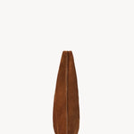 Side view of bistre small suede bindle bag on white background, with no model shown.
