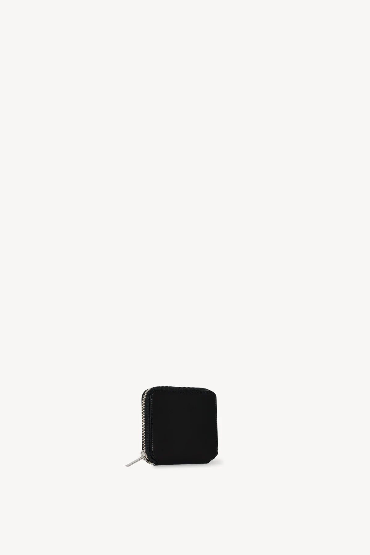 Front slanted view of black small zip wallet on white background, with no model shown.