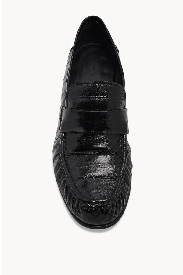 Overhead view of black soft loafer in eel on white background, with no model shown.