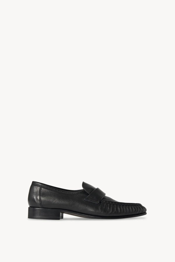 Right side view of black soft loafer on white background, with no model shown.