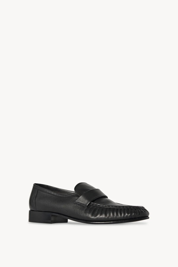 Right side slanted view of black soft loafer on white background, with no model shown.