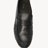 Overhead view of black soft loafer on white background, with no model shown.