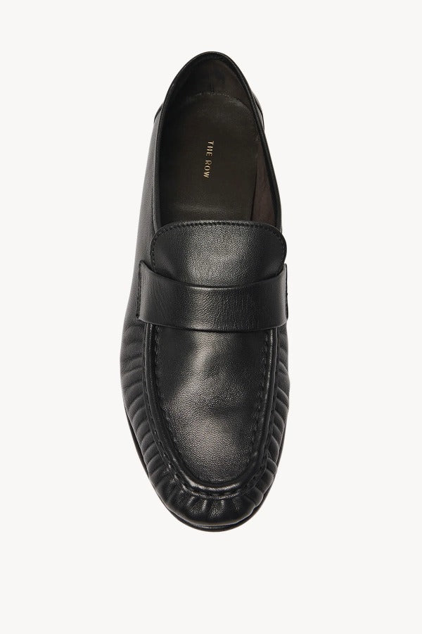 Overhead view of black soft loafer on white background, with no model shown.
