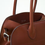 Closeup view of Soft Margaux 10 Bag in brown pictured on white background with no model