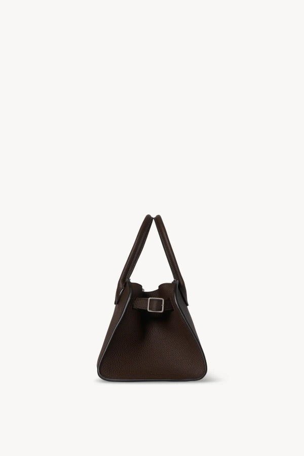 Side view of deep brown soft margaux 10 bag on white background, with no model shown.