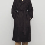 Front view of dark brown solana coat on model wearing khaki pants and mules, against a white background.