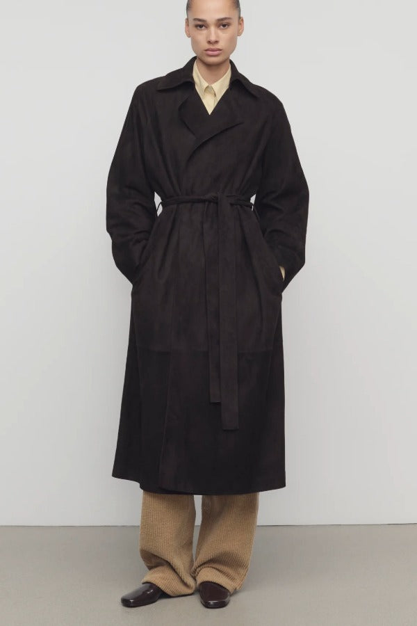 Front view of dark brown solana coat on model wearing khaki pants and mules, against a white background.