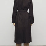Back view of dark brown solana coat on model wearing khaki pants and mules, against a white background.