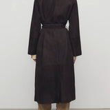 Back view of dark brown solana coat on model wearing khaki pants and mules, against a white background.