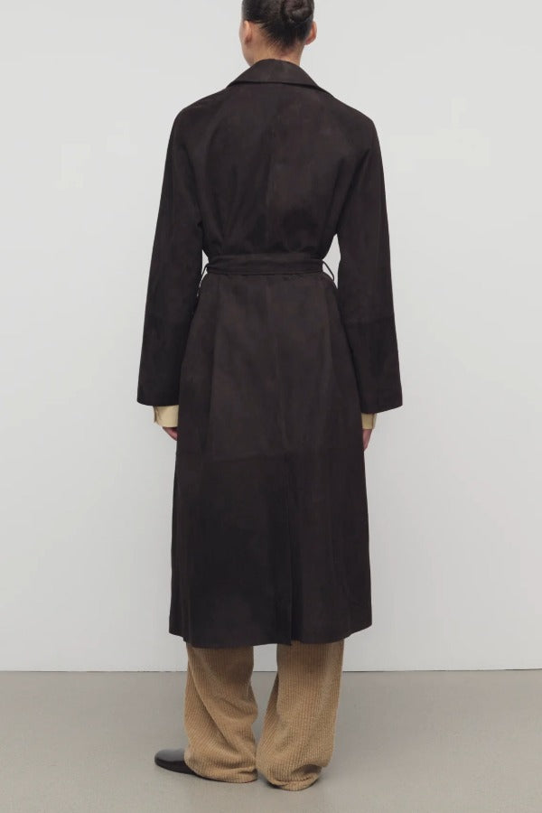 Back view of dark brown solana coat on model wearing khaki pants and mules, against a white background.