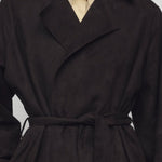 Front closeup view of dark brown solana coat on model wearing yellow shirt, against a white background.