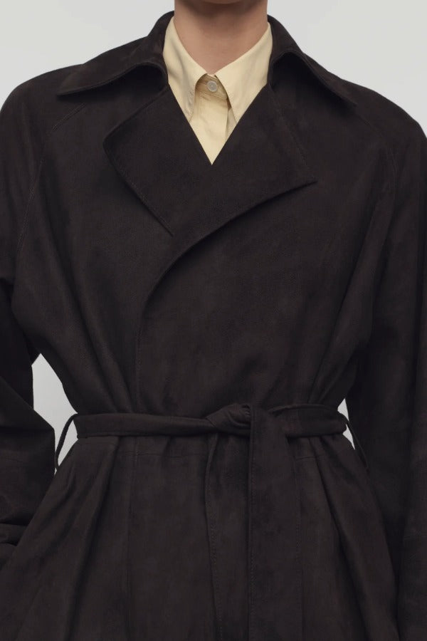 Front closeup view of dark brown solana coat on model wearing yellow shirt, against a white background.