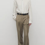 Front view of military beige sorina pant on model wearing stripe shirt and flats, against a white background.