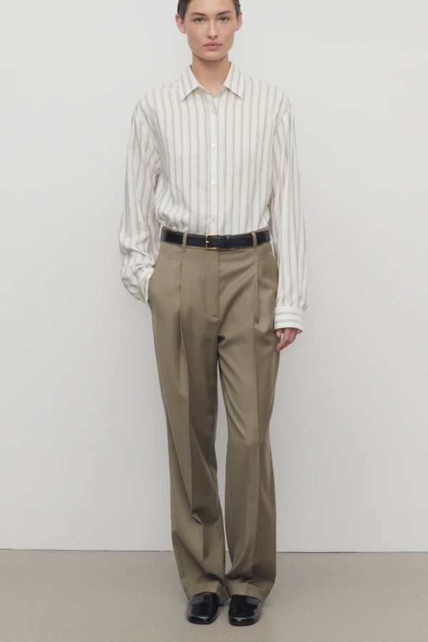 Front view of military beige sorina pant on model wearing stripe shirt and flats, against a white background.