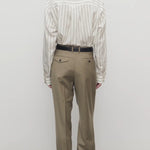Back view of military beige sorina pants on model wearing striped shirt and flats, against a white background.
