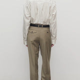 Back view of military beige sorina pants on model wearing striped shirt and flats, against a white background.