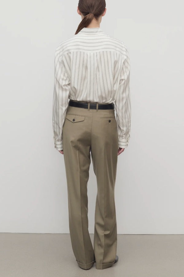 Back view of military beige sorina pants on model wearing striped shirt and flats, against a white background.