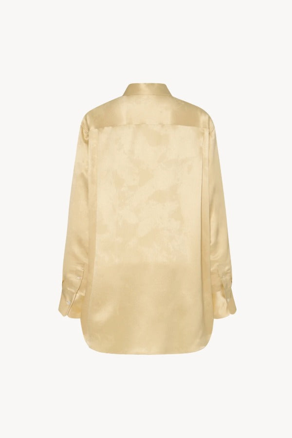 Back view of sand takara shirt on white background, with no model shown.