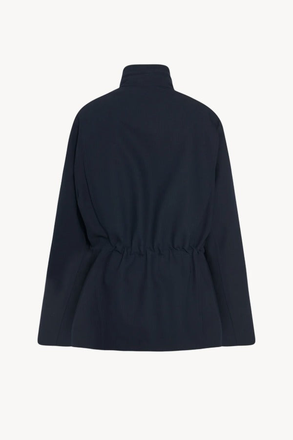 Back view of navy tanera jacket on white background, with no model shown.