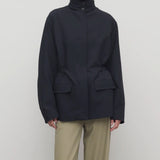 Front view of navy tanera jacket on model wearing khaki pants, against a white background.