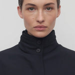 Front closeup view of navy tanera jacket on model, against a white background.