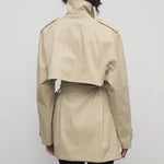 Back view of sandstone tavoris jacket on model wearing black leggings, against a white background.