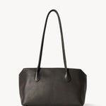 Front view of dark brown terrasse bag on white background, with no model shown.