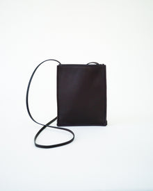 Front view of black leather bag on white background, with no model shown.