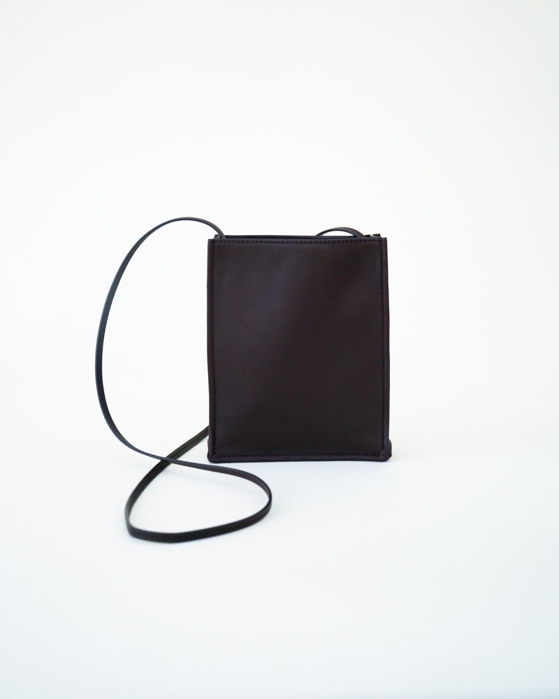 Front view of black leather bag on white background, with no model shown.