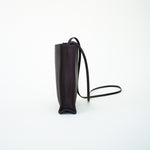 Side view of black leather bag on white background, with no model shown.
