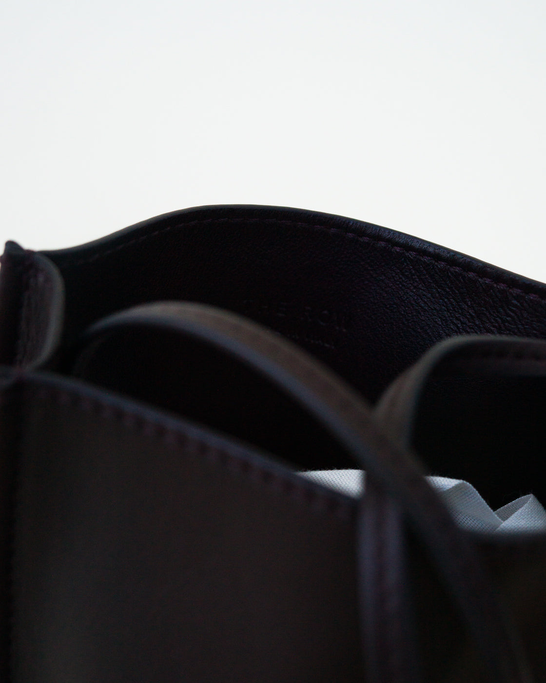 Closeup view of black leather bag on white background, with no model shown.