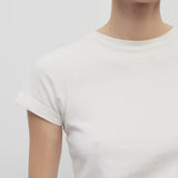 Front closeup view of white tori top on model against a white background.