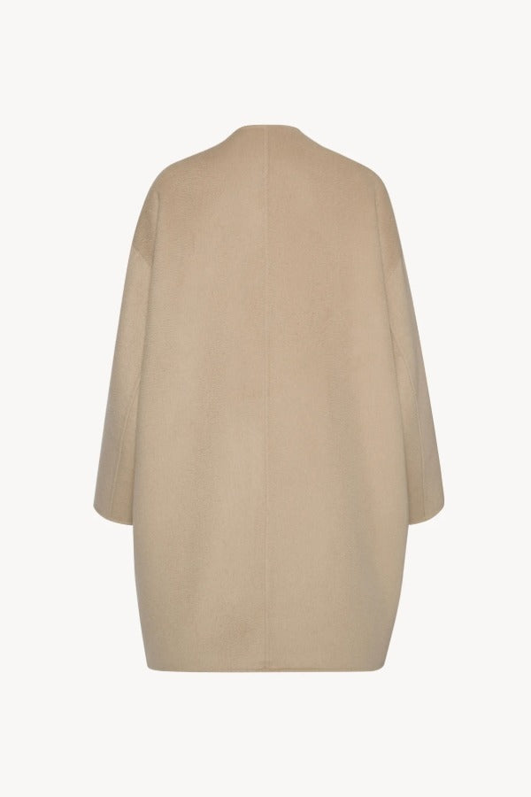 Back view of light pebble verlain coat on white background, with no model shown.