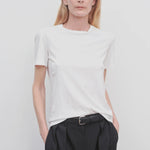 Front view of white welser t-shirt on model wearing black trousers, against a white background.