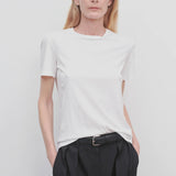Front view of white welser t-shirt on model wearing black trousers, against a white background.