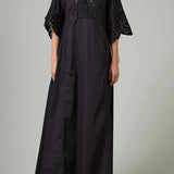 Front view of black rachel long dress on model wearing black flats, against a white background.