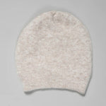 Folded view of camel knitted cap on grey background, with no model shown.