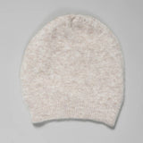 Folded view of camel knitted cap on grey background, with no model shown.
