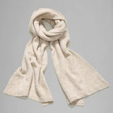 Rolled view of camel knitted scarf on grey background, with no model shown.