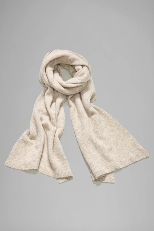 Rolled view of camel knitted scarf on grey background, with no model shown.