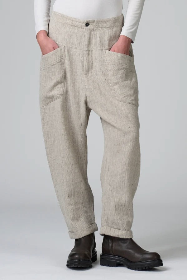 Front view of chalk low crotch comfort fit trouser on model wearing white t-shirt, against a grey background.