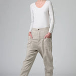 Front view of chalk low crotch comfort fit trouser on model wearing white t-shirt, against a grey background.