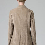 Back view of camel regular fit jacket on model wearing camel pants, against a grey background.