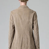 Back view of camel regular fit jacket on model wearing camel pants, against a grey background.